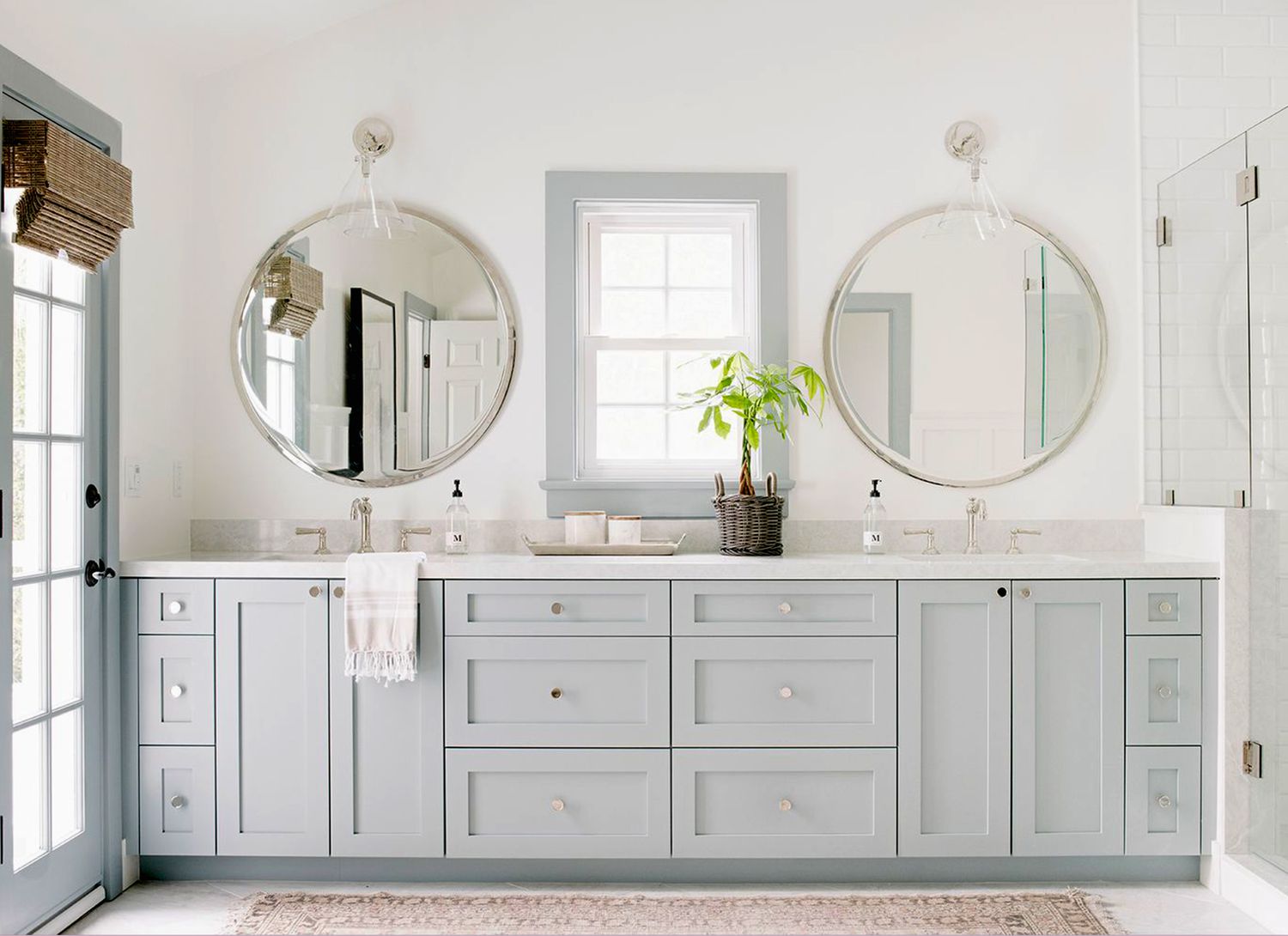 modern spa-like bathroom vanity with two round mirrors