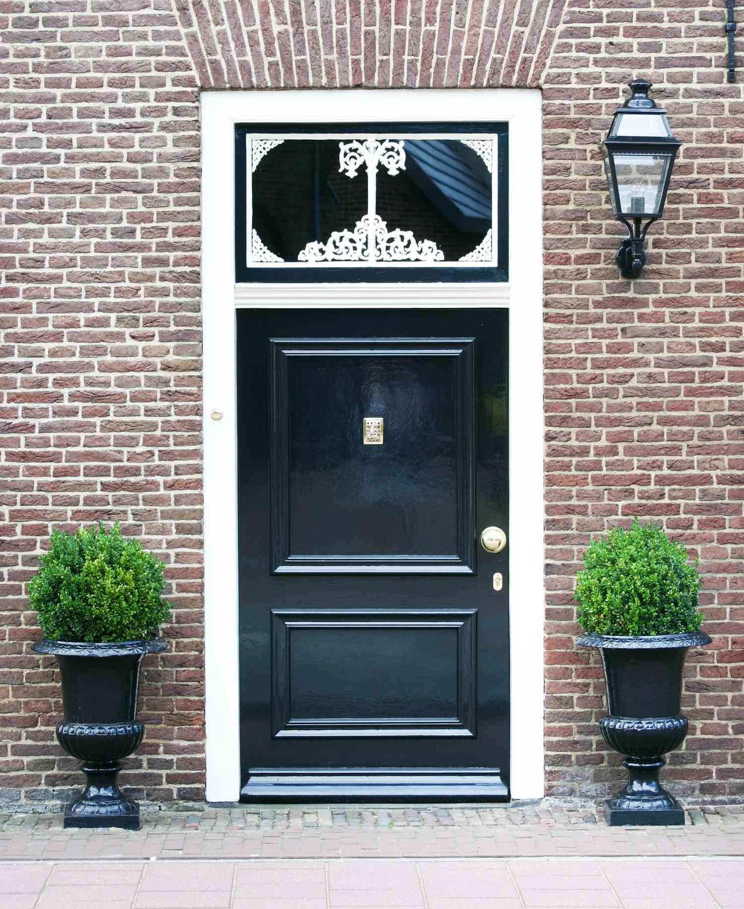 Front door with two boxwood plants