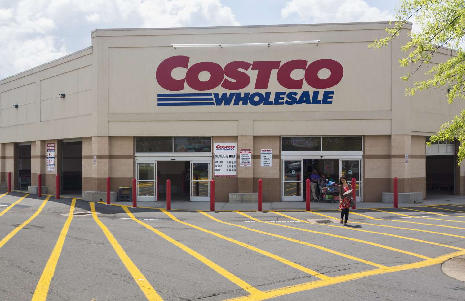 Entrance of a Costco Wholesale store with people walking outside
