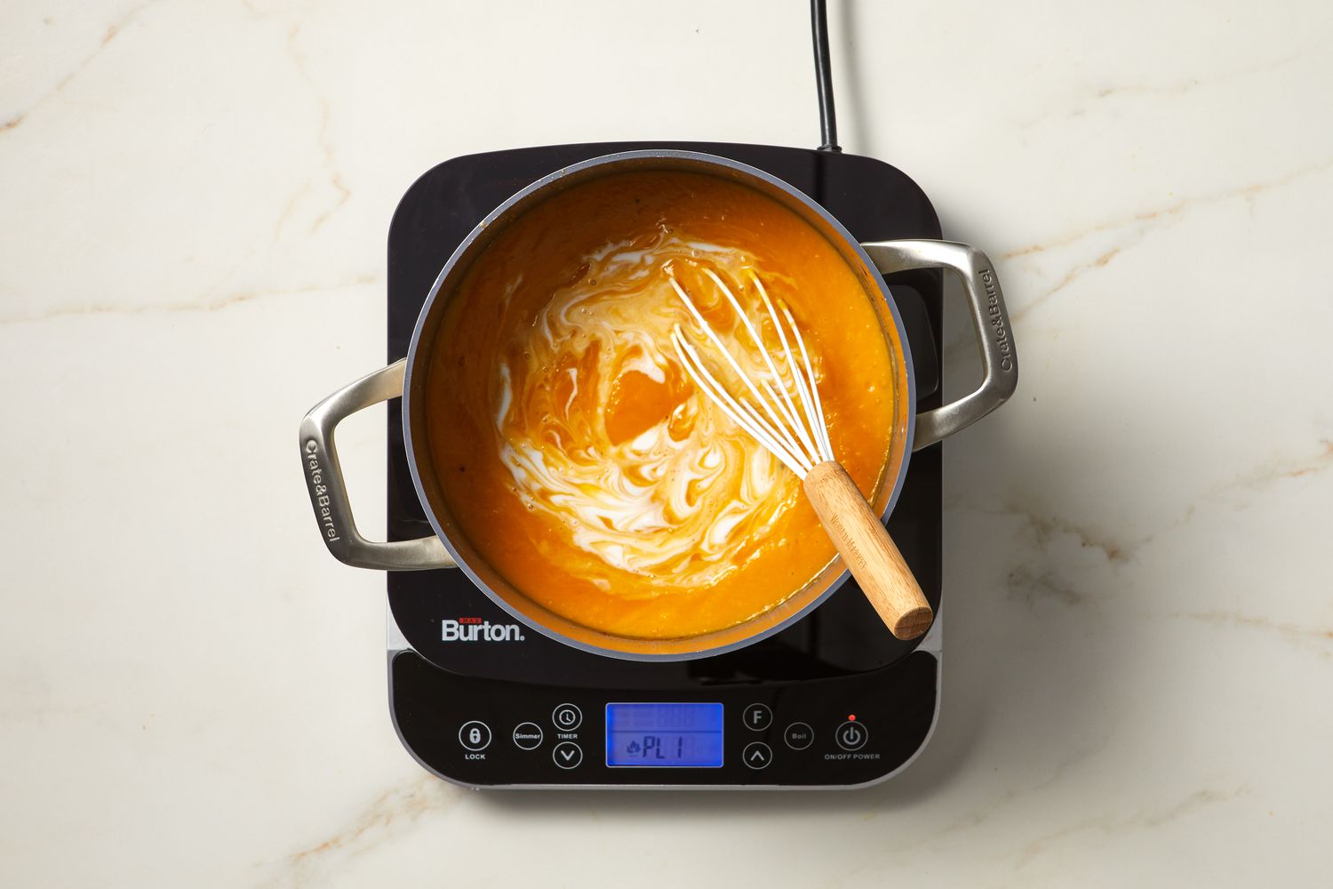 soup on burner with whisk
