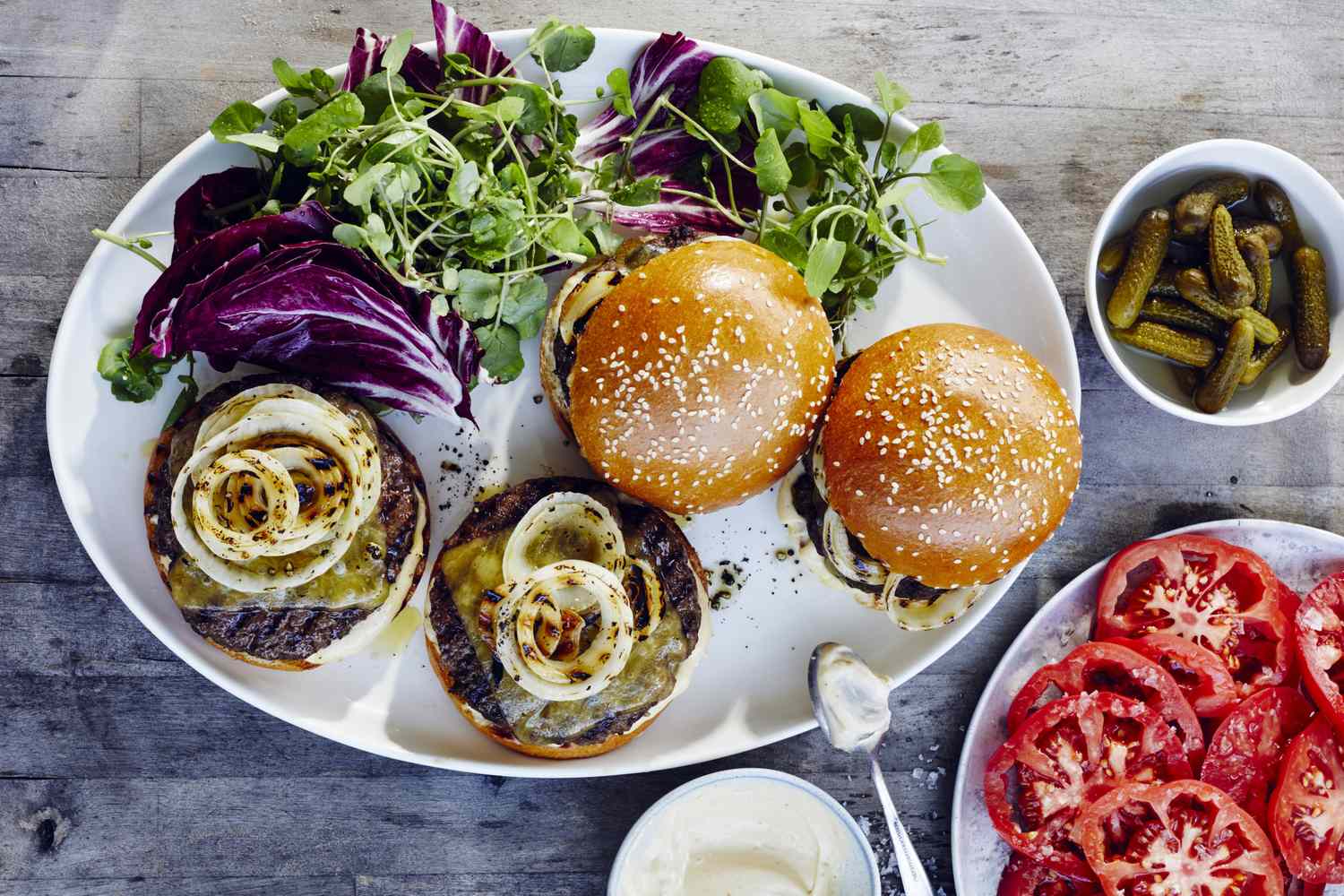 bistro burgers with grilled onions and cheese on white platter