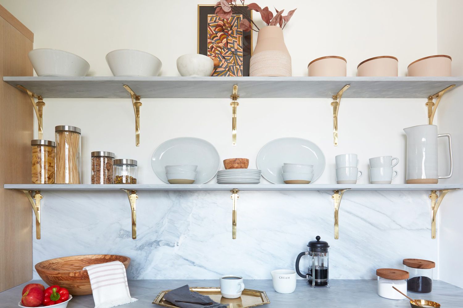 Shelves holding plates and bowls in kitchen