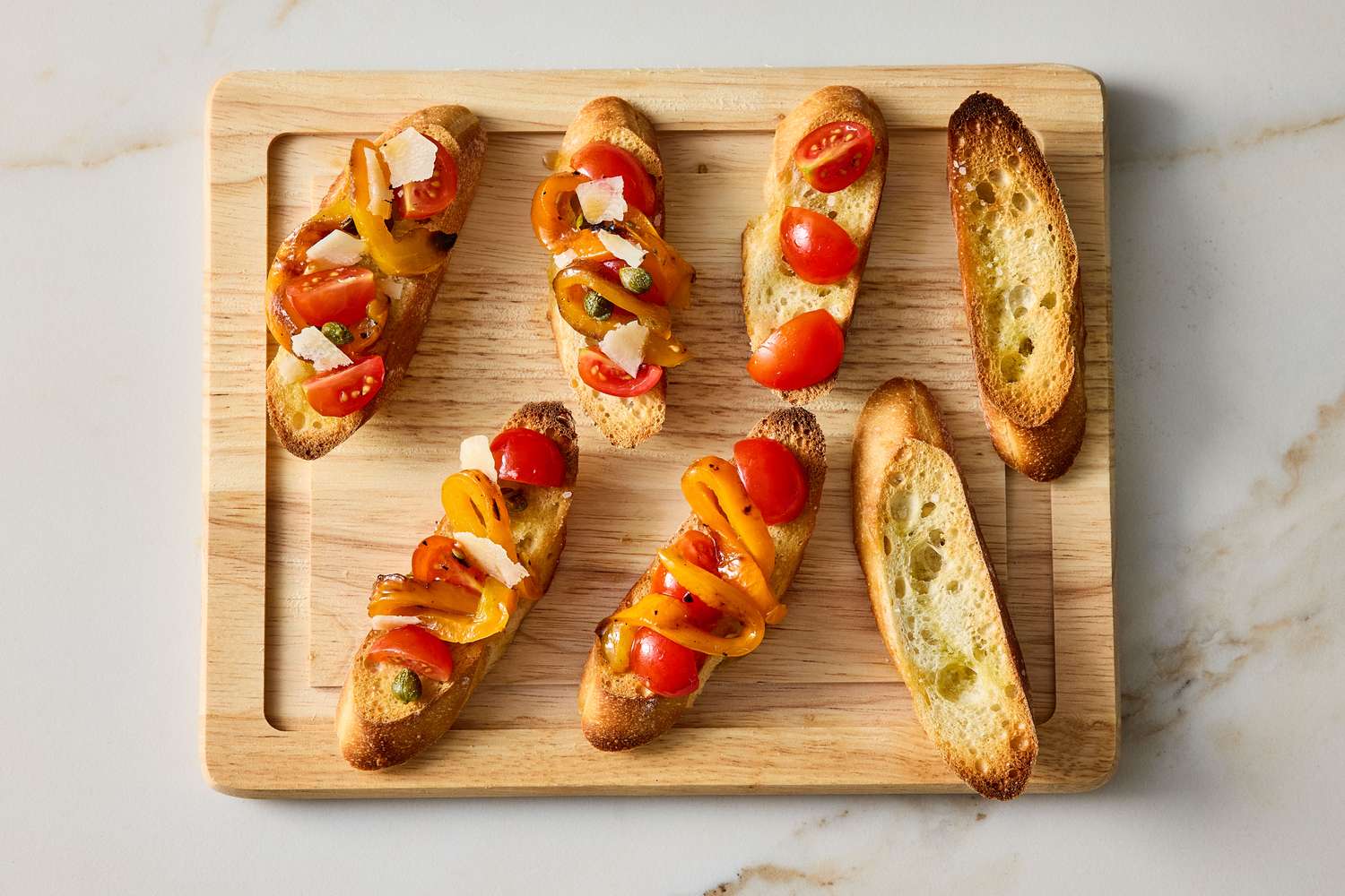 Grilled pepper bruschetta on a wooden cutting board