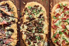 3 different pizzas on grilling planks