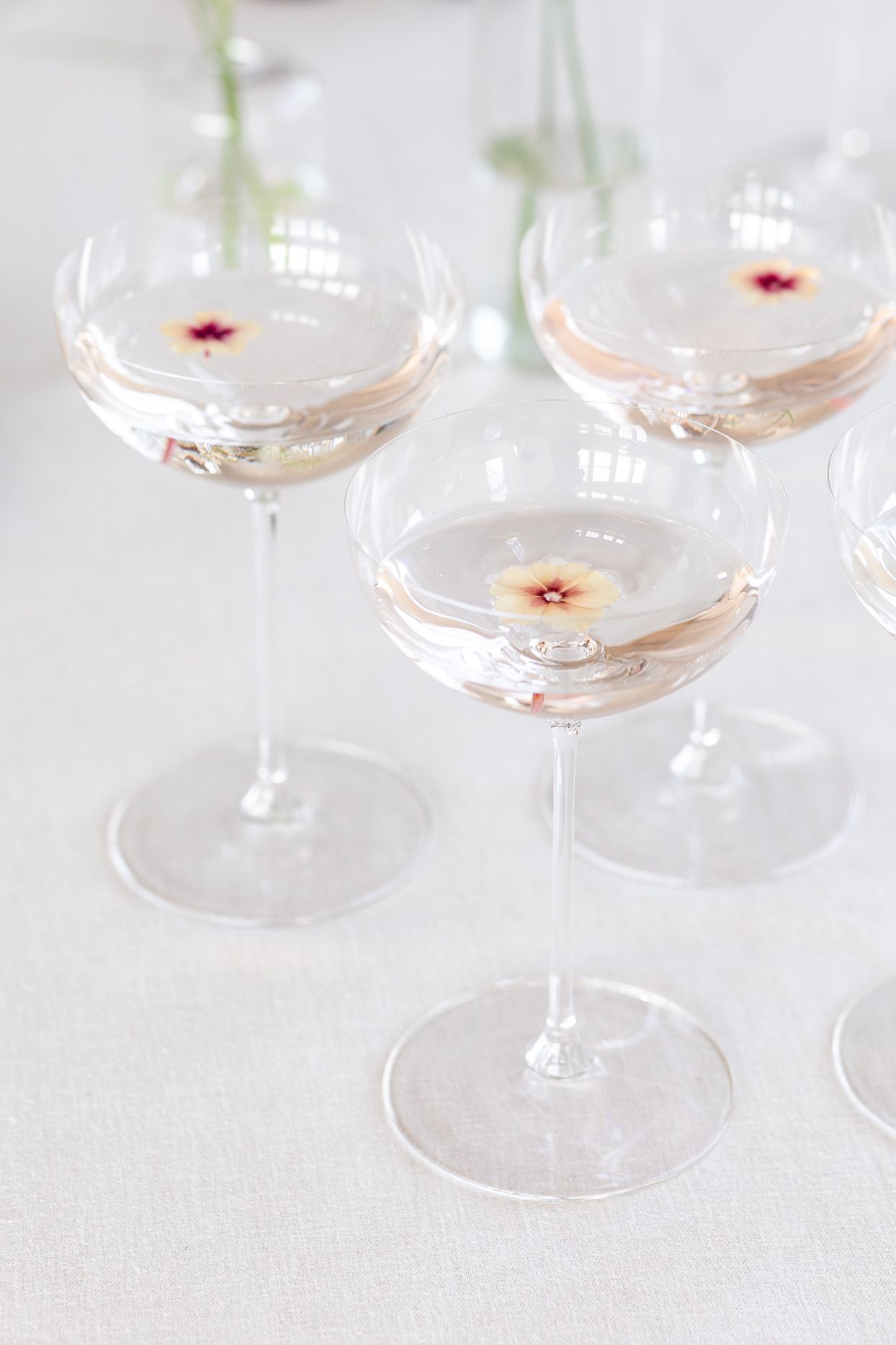 champagne coupes topped with delicate flowers