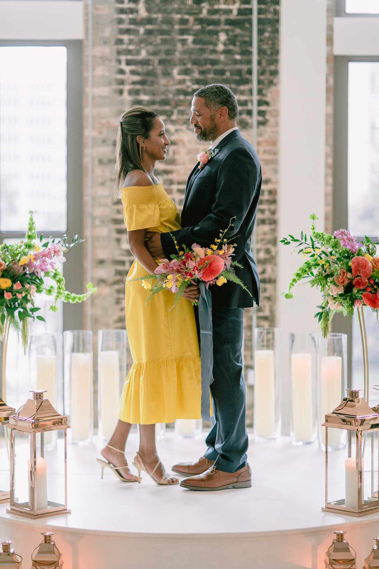 bride and groom first look in front of brick wall