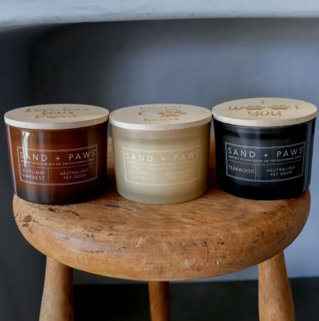 Three Sand Paws candles on a wooden stool