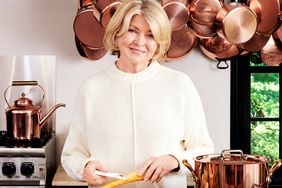 martha standing in kitchen with copper pots and pans