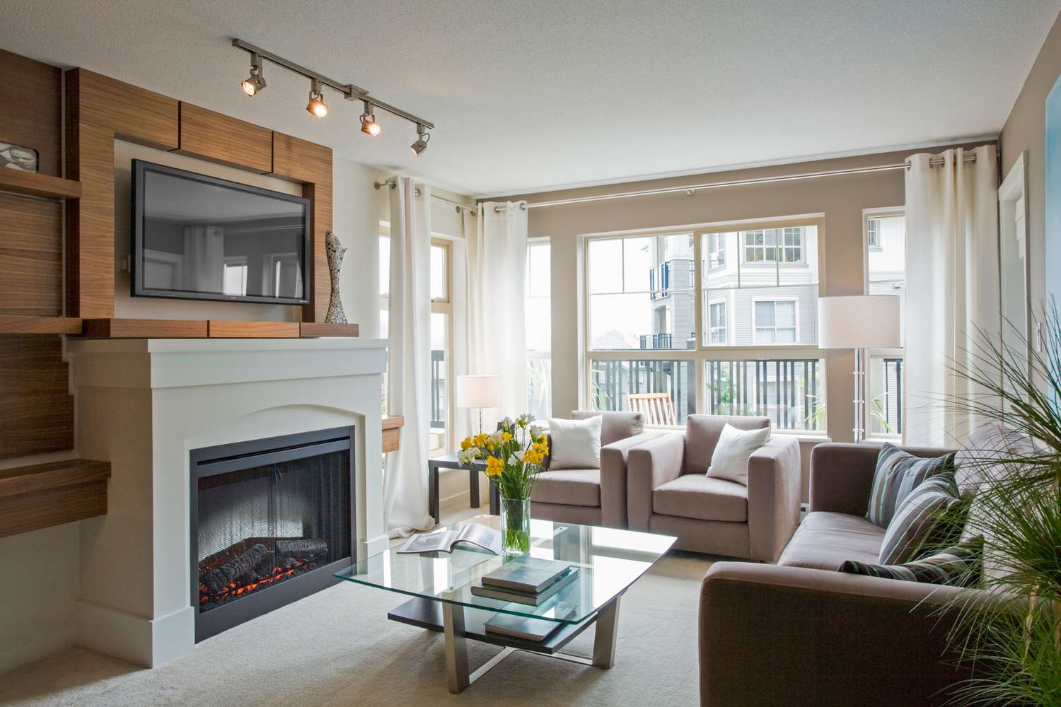 Tv mounted over fireplace in modern living room