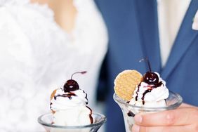 bride and groom each holding an ice cream sundae