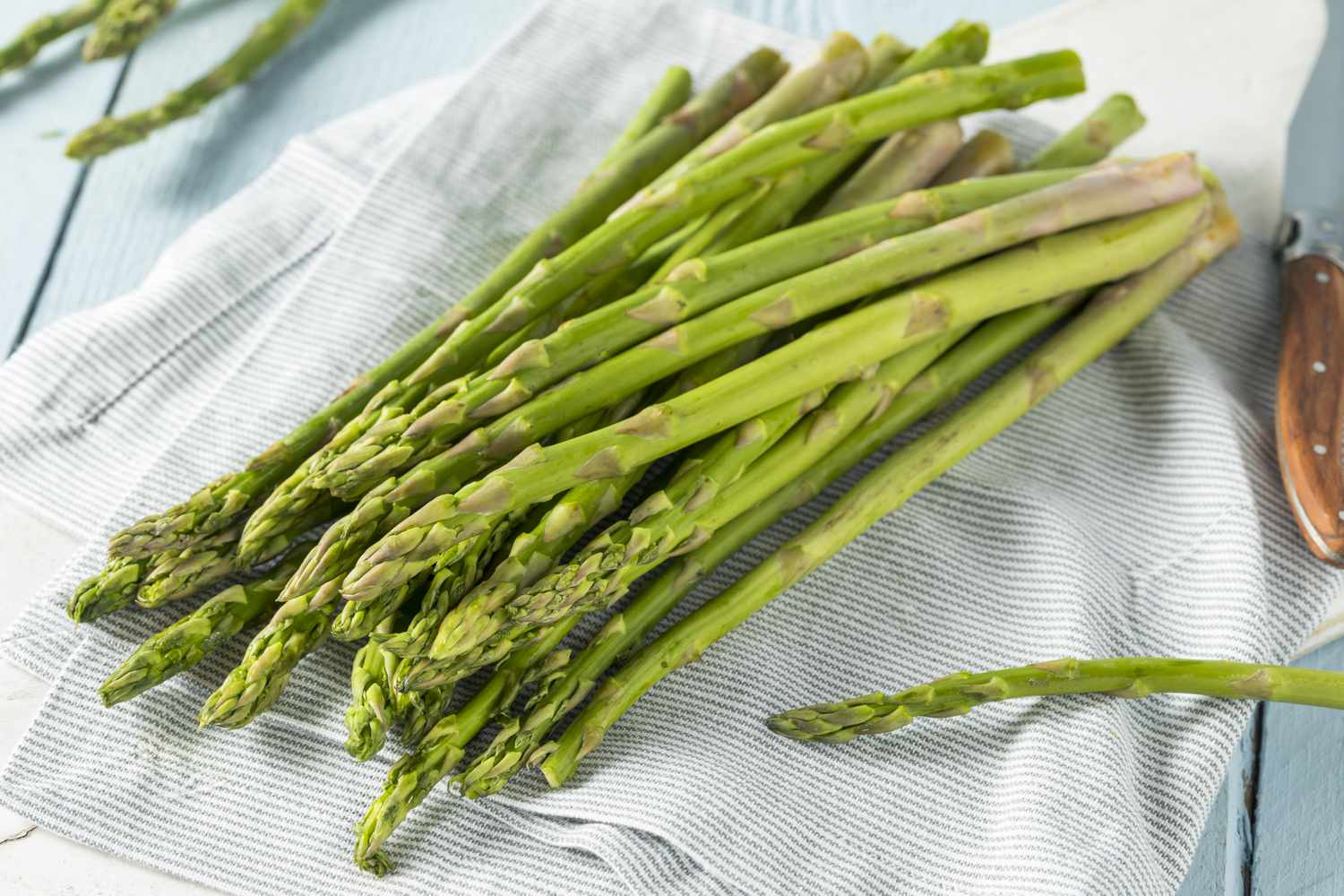 raw asparagus on striped towel