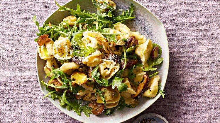 mushroom tortellini with arugula on plate