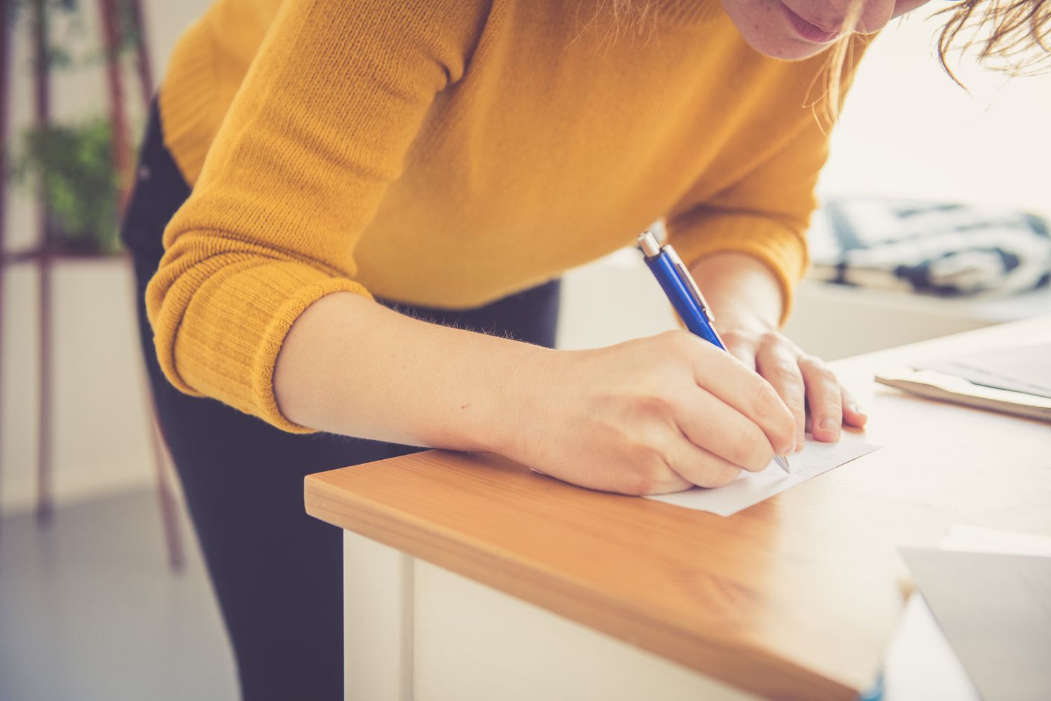 woman writing a note