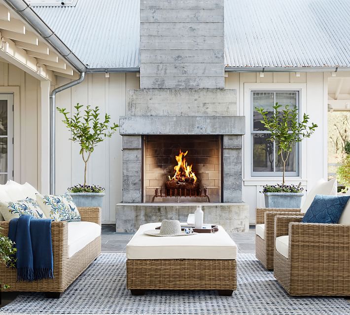 outdoor patio space with fireplace and rug