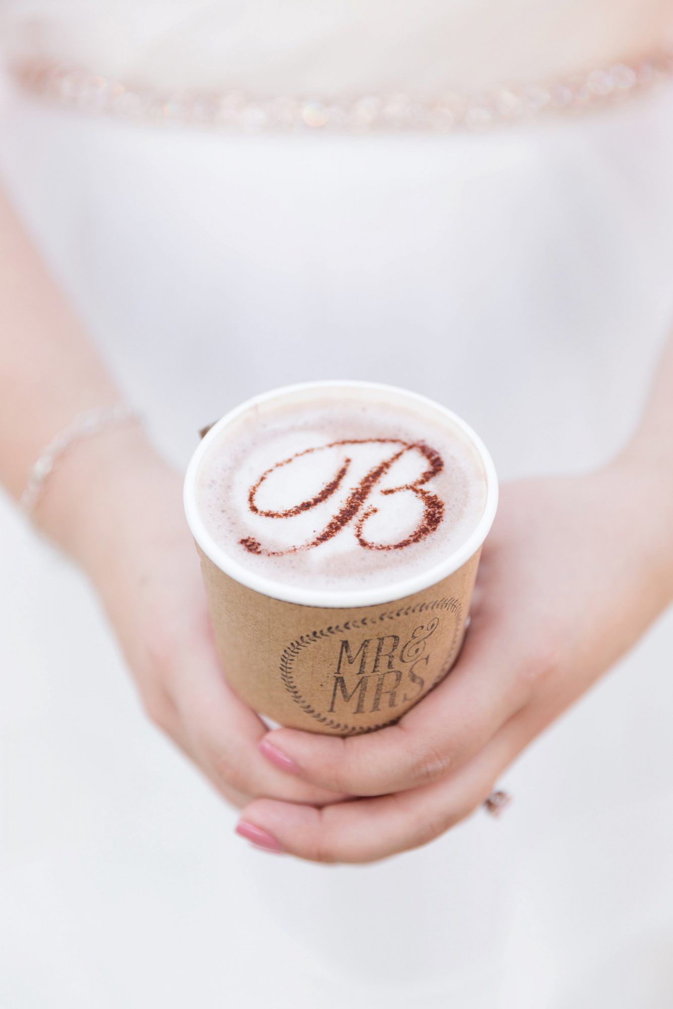 coffee wedding ideas woman holding monogrammed foam