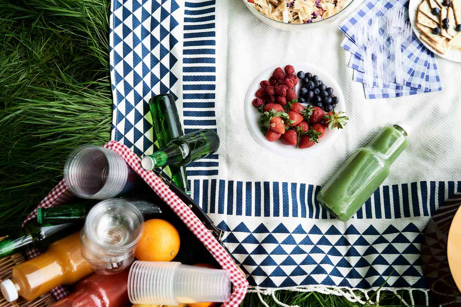 picnic blanket with food and drinks