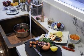 Fruit being washed in a copper sink