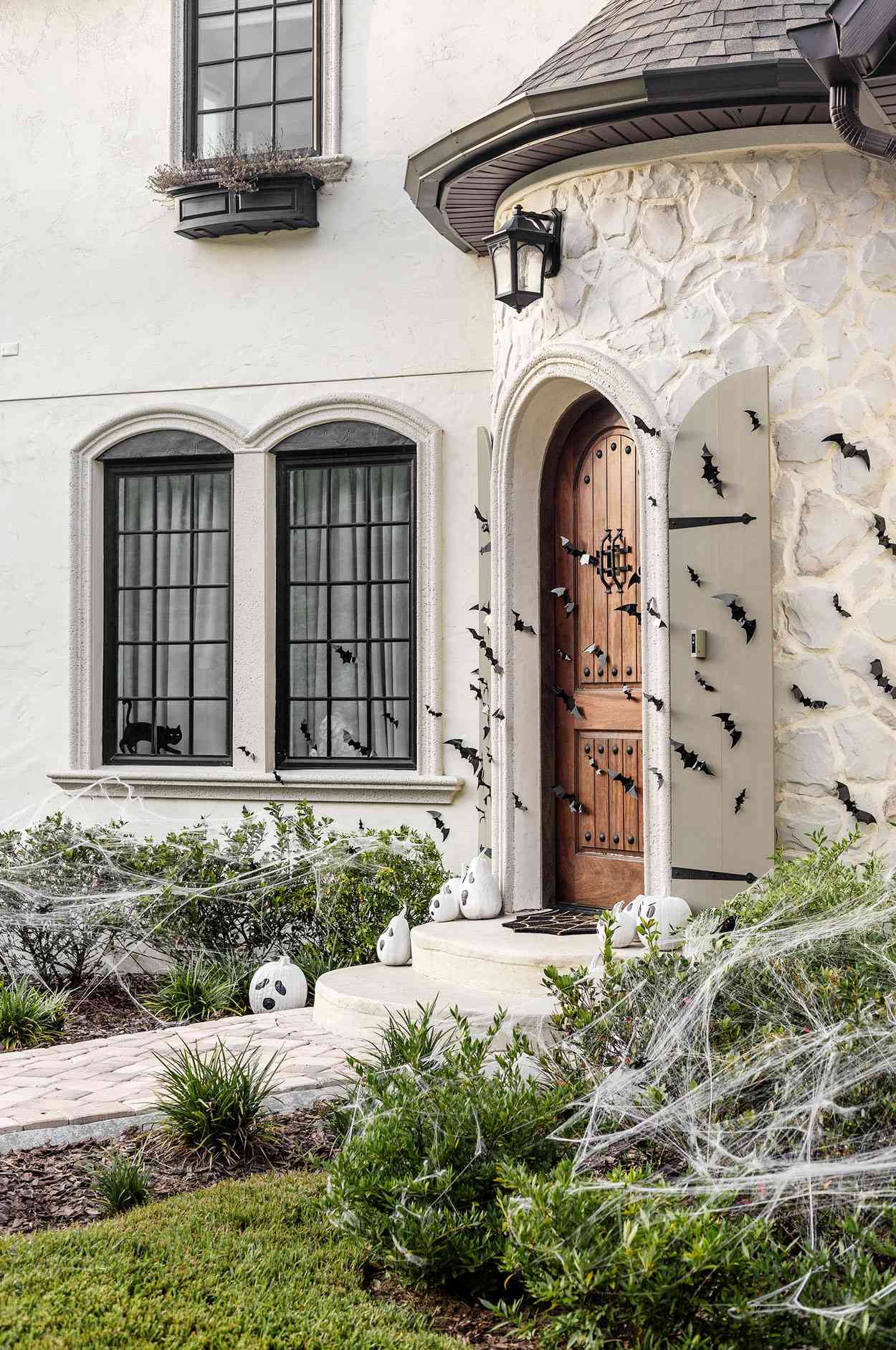 fall porch with bats spiders and ghost pumpkins
