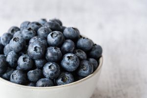 Close up of fresh blueberries in a white ceramic bowl 