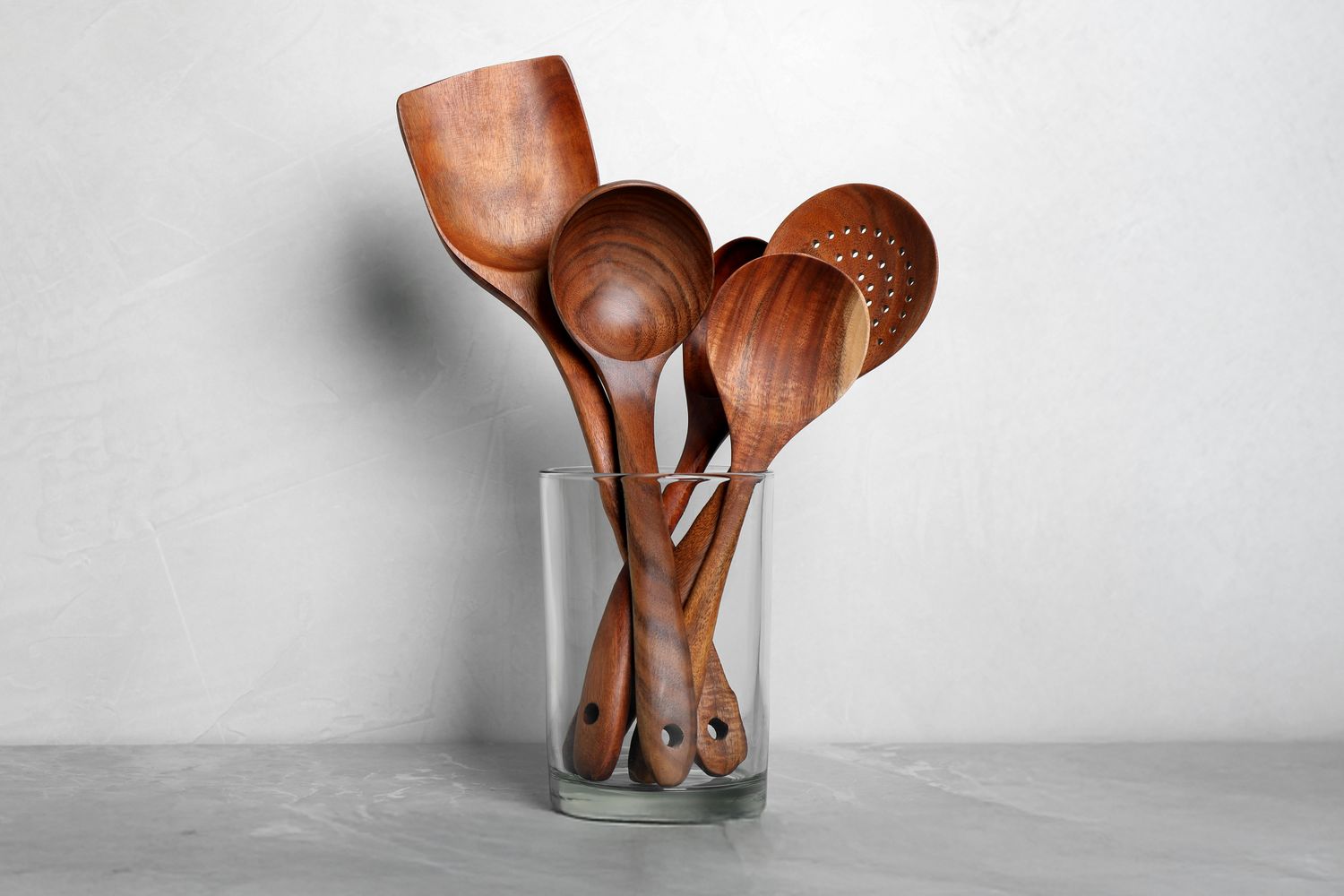 Wooden kitchen utensils in a glass container