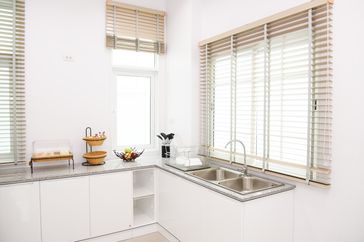 Modern kitchen interior with a sink countertop and fruits in a bowl on the counter