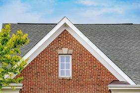 Close-up of a gable roof on front exterior of brick townhouse
