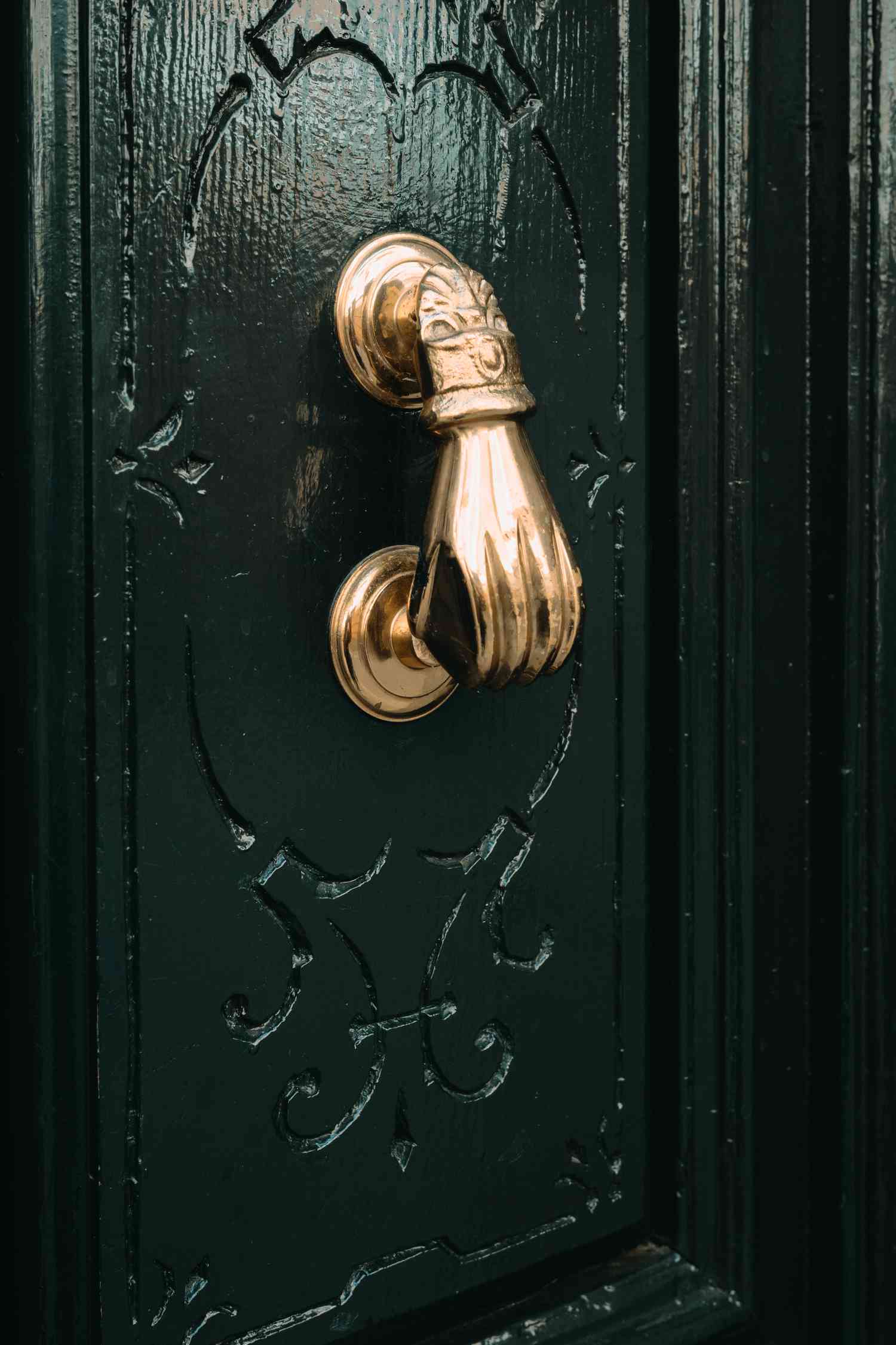 Dark green door with gold knocker