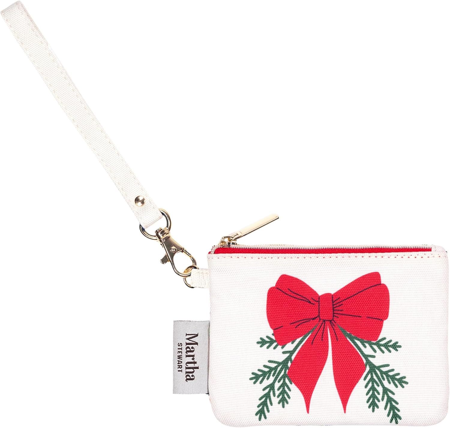 A wristlet pouch with a festive bow and green branches design