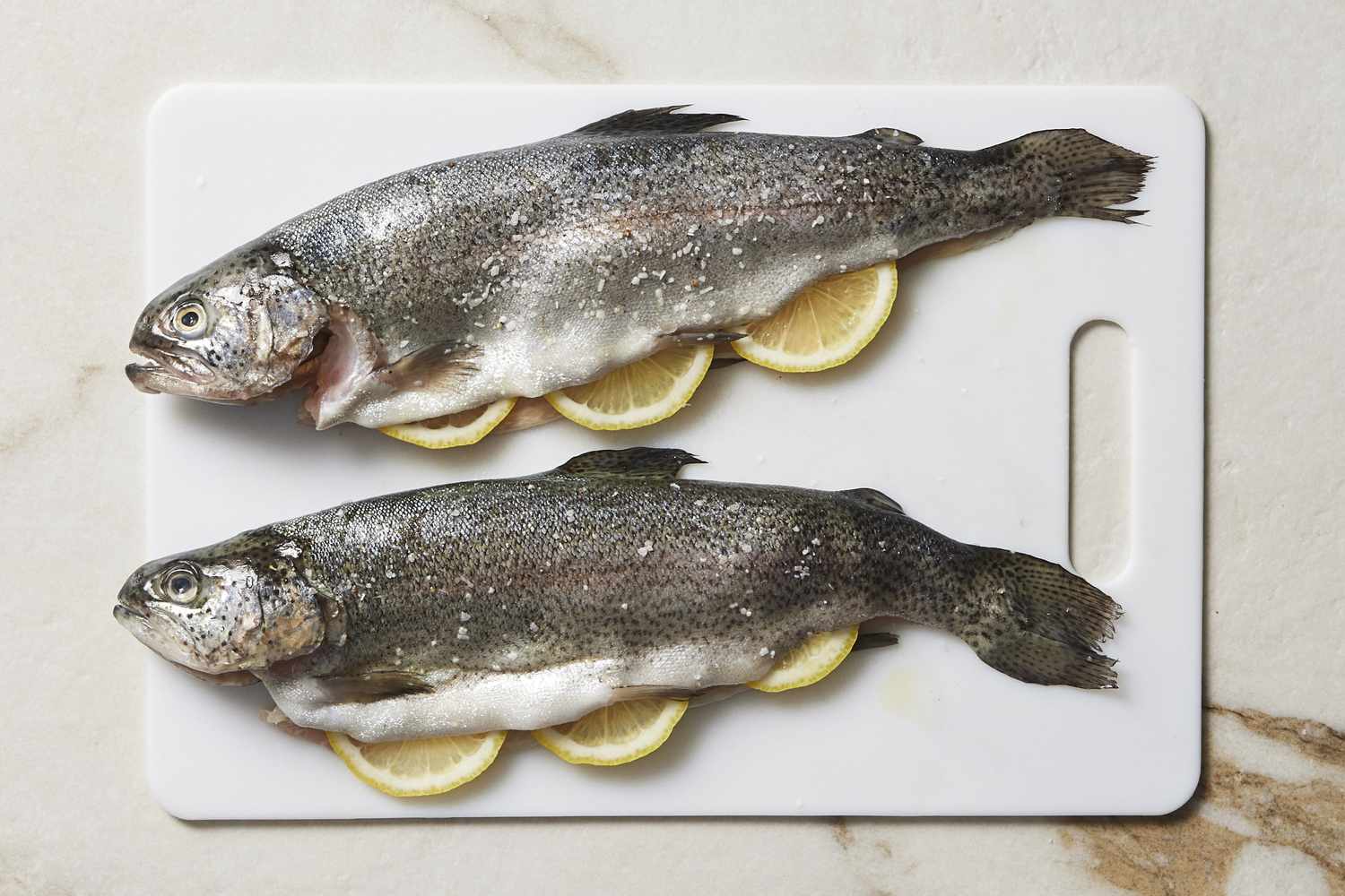 Seasoned trout on cutting board
