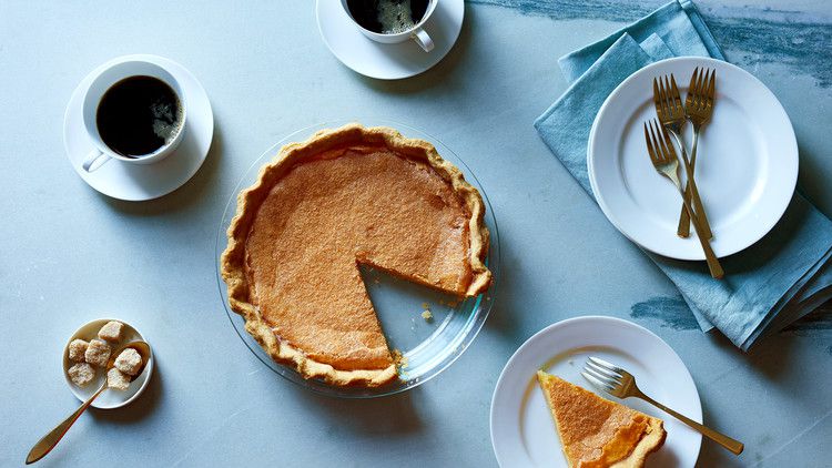 classic pumpkin pie on blue table with coffee