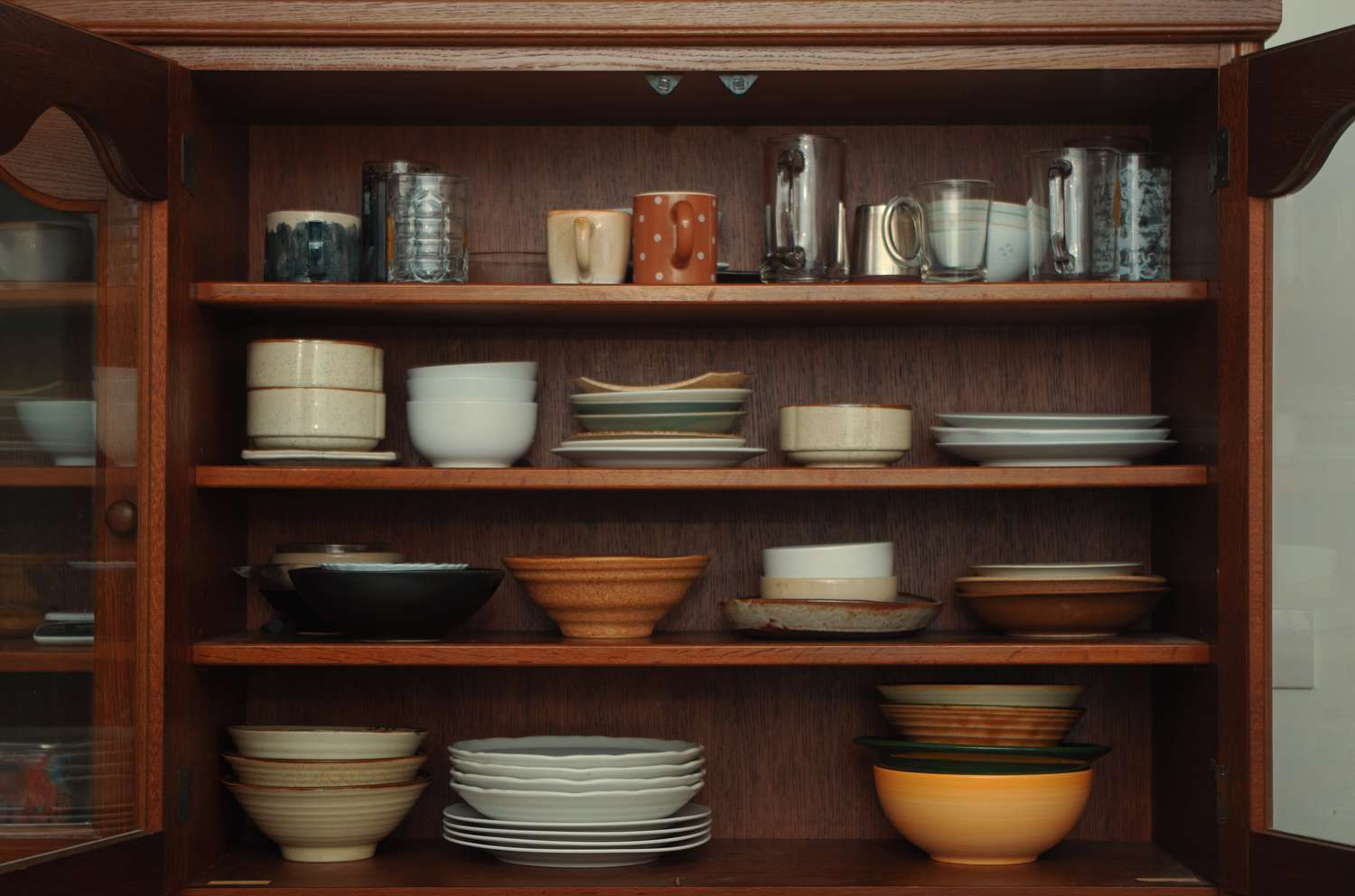 A shelf full of plates and ceramics