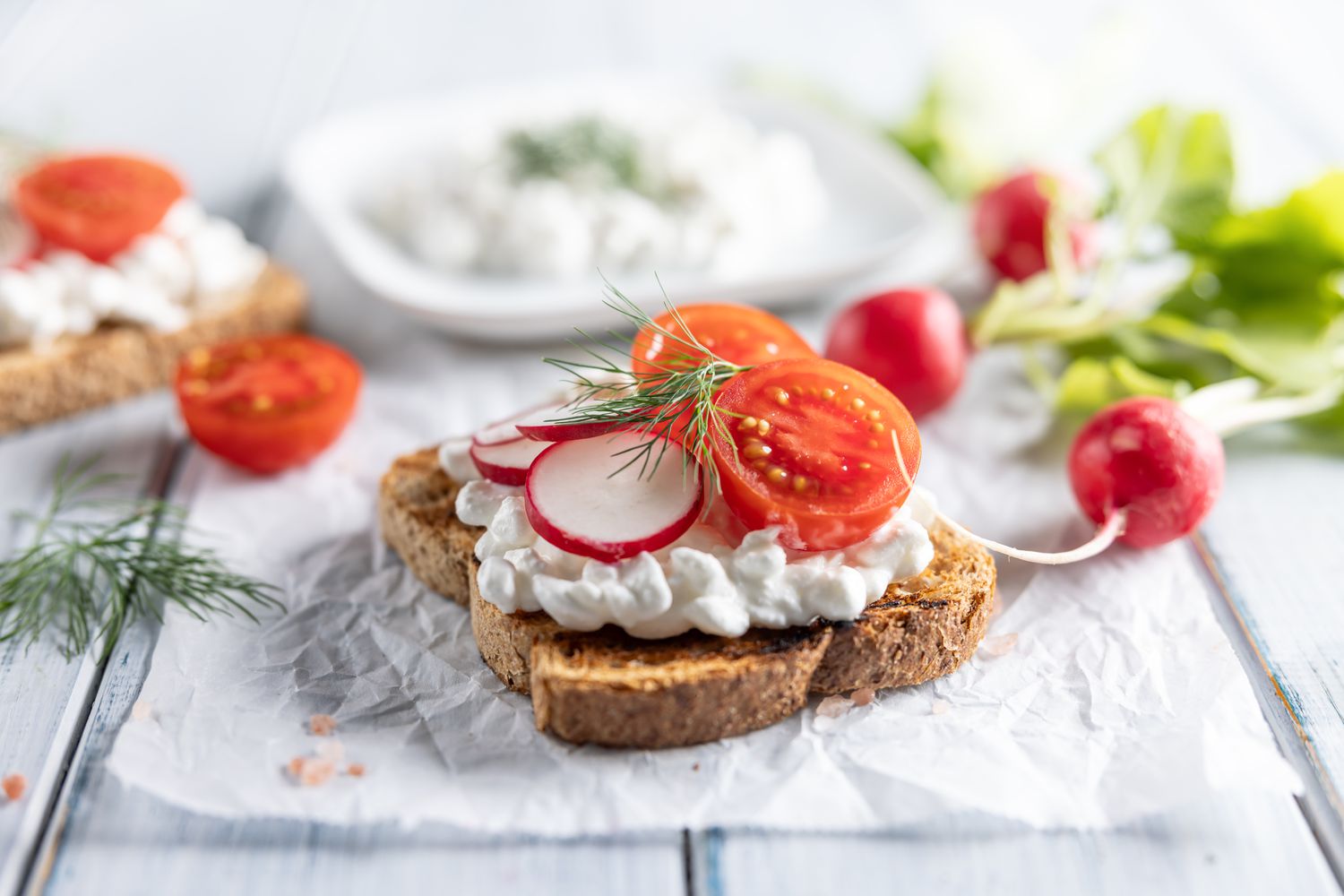 Toast with cottage cheese, radish, cherry tomatoes and dill