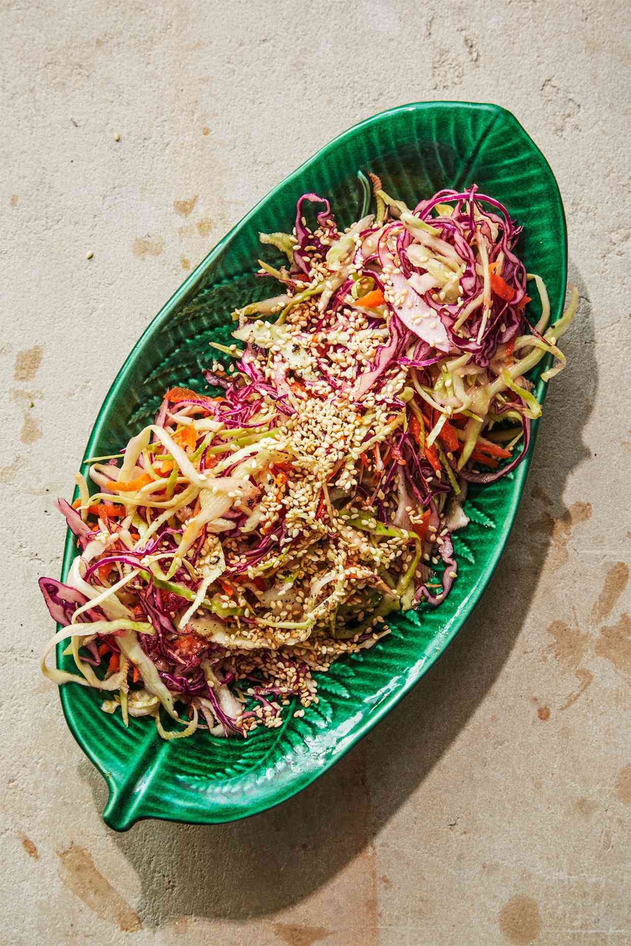 shredded cabbage with ginger vinaigrette topped with sesame seeds