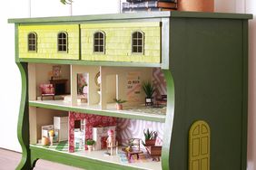 green dresser with dollhouse inside