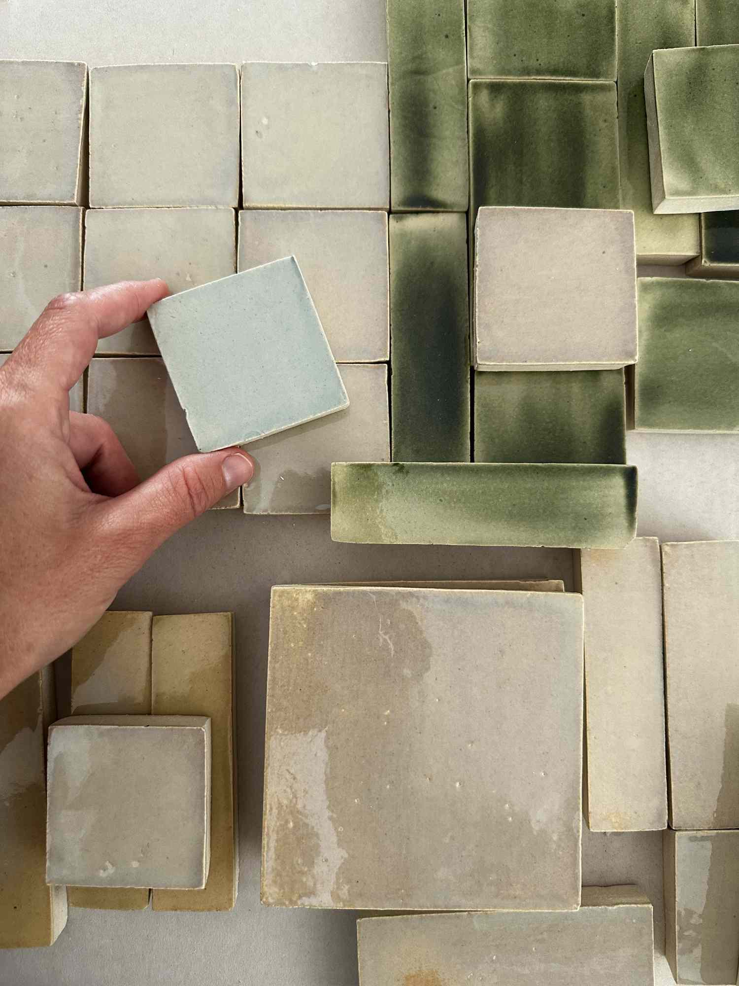 Different colored tiles and sizes laid out. 