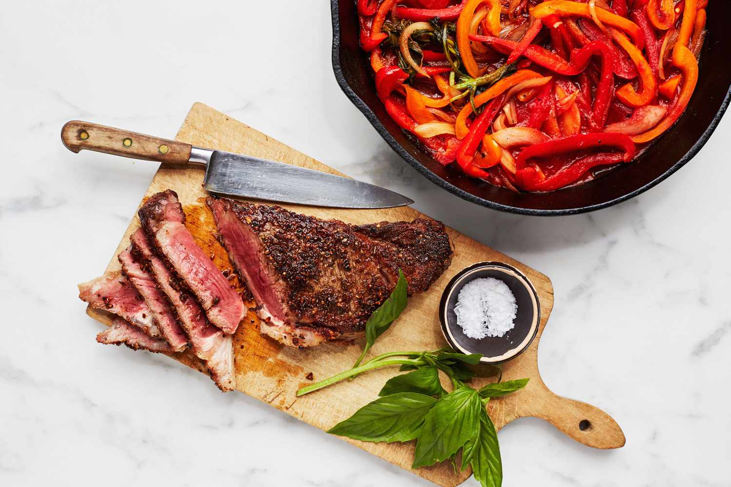 seared strip steaks with braised peppers and onions