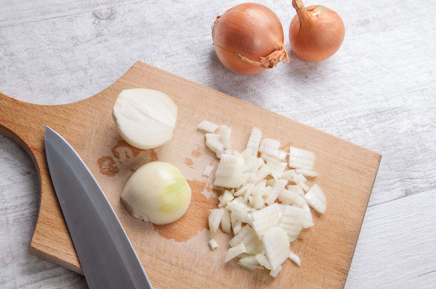 Diced onion on wooden cutting board