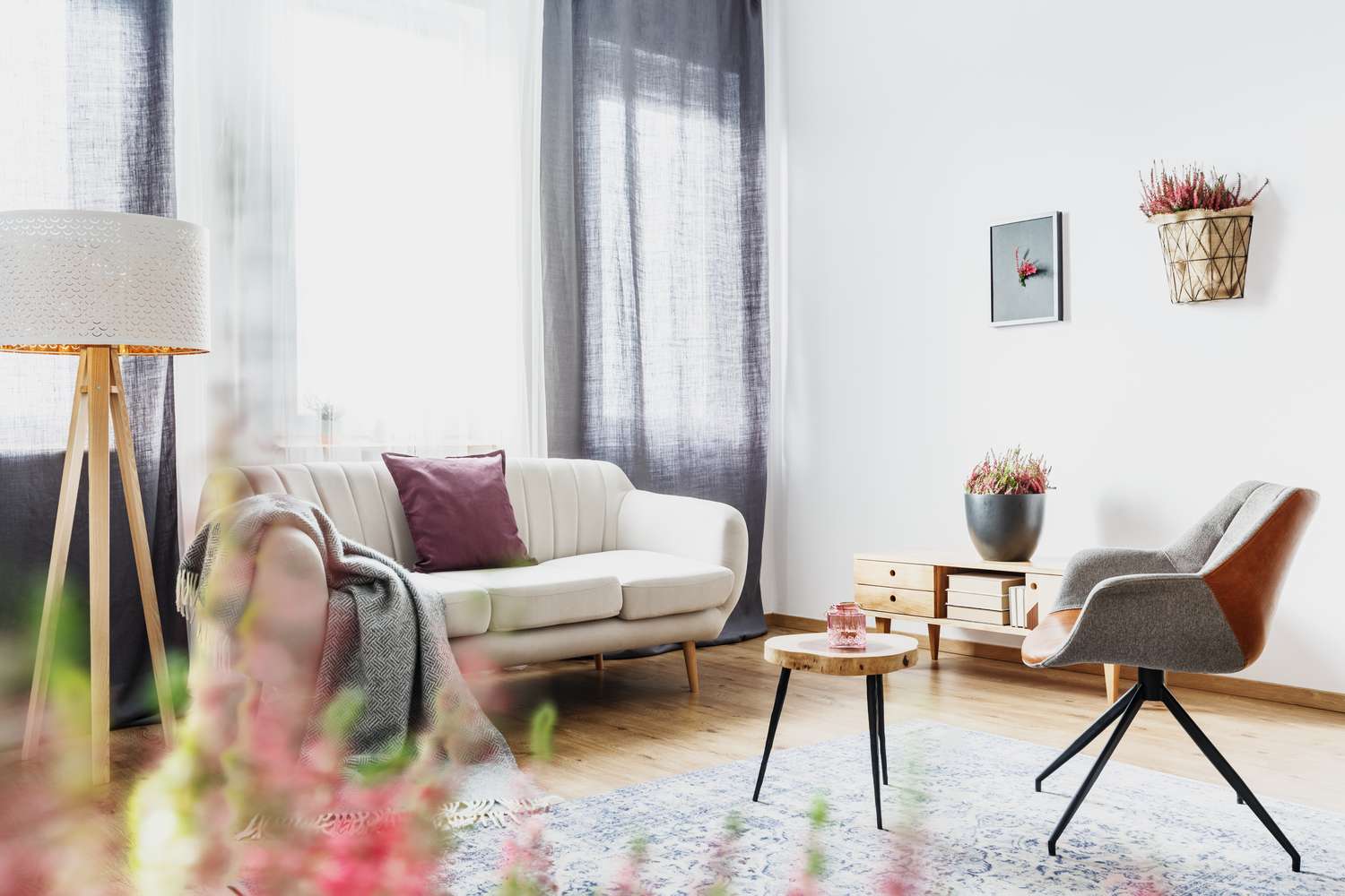 A modern living room setup with a couch armchair coffee table and floor lamp