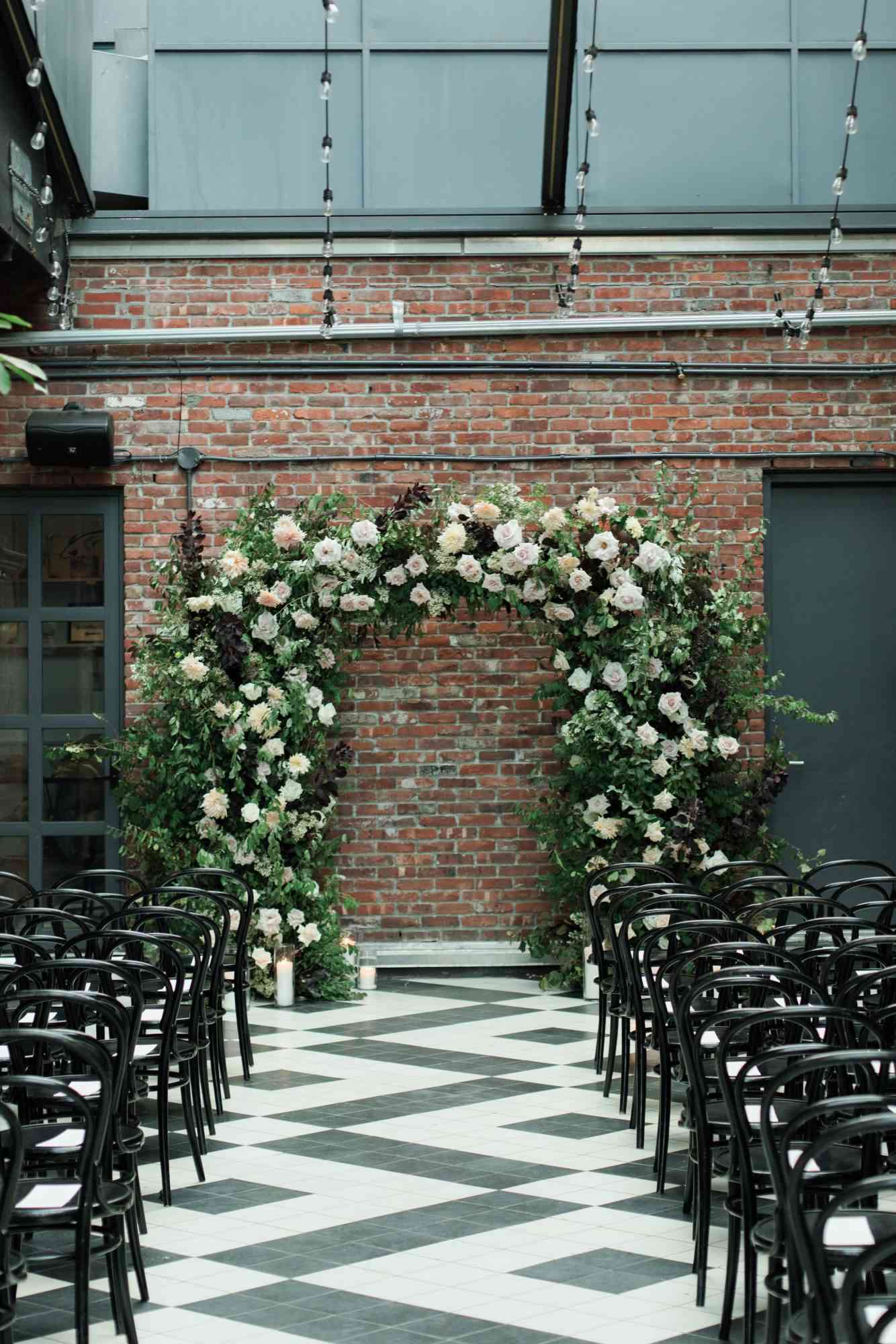 indoor wedding venue with a floral arch