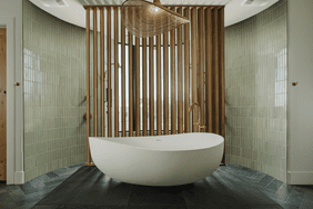 A bathroom with green tiles