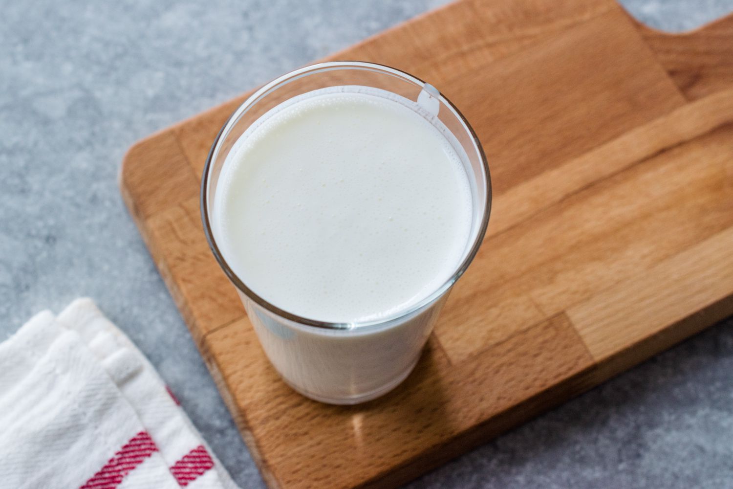 kefir in a glass on a wooden board
