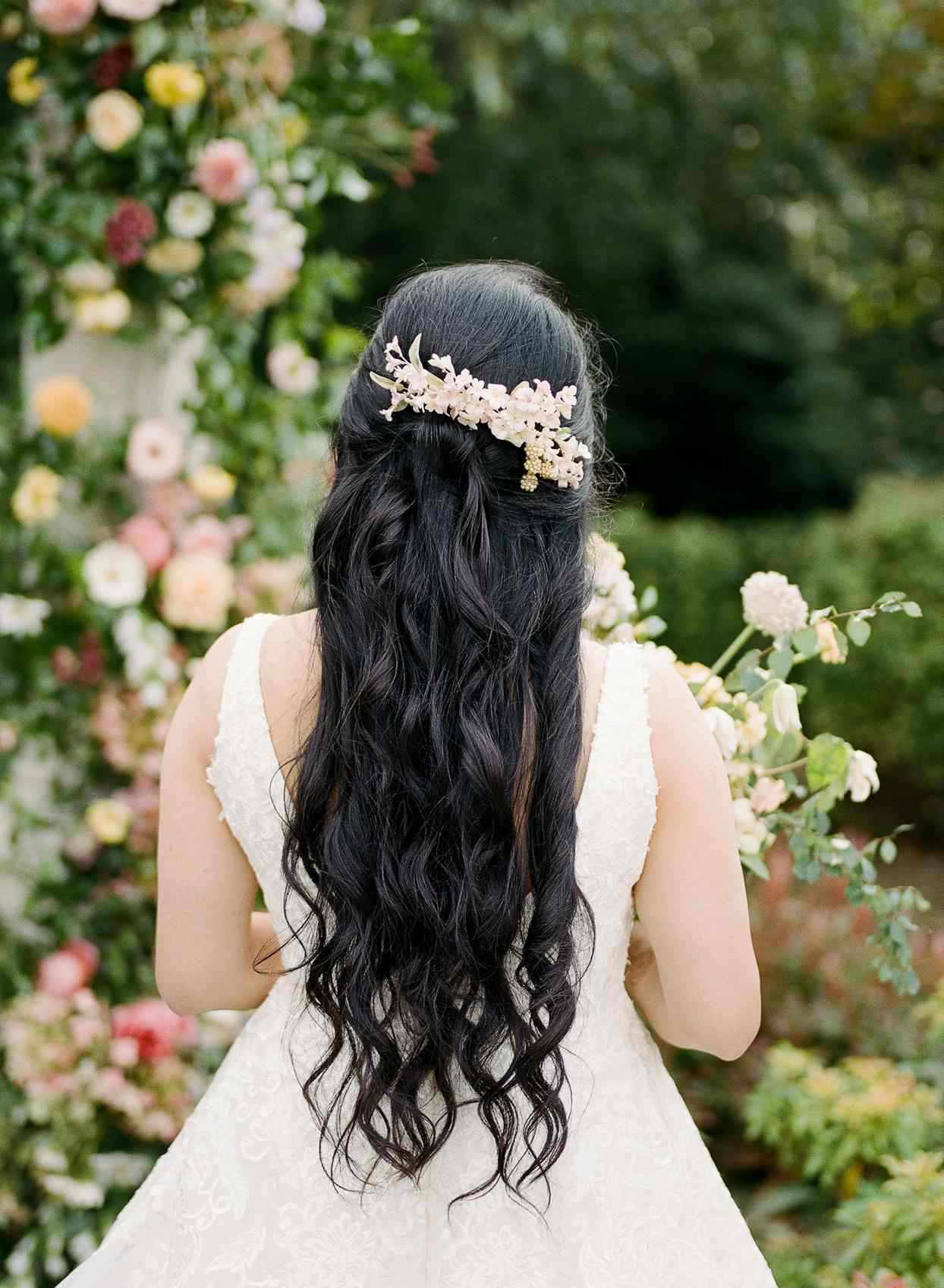 half-up, half-down wedding hairstyle with floral hairpiece