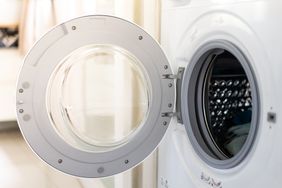 Open door of a frontloading washing machine showing the interior drum