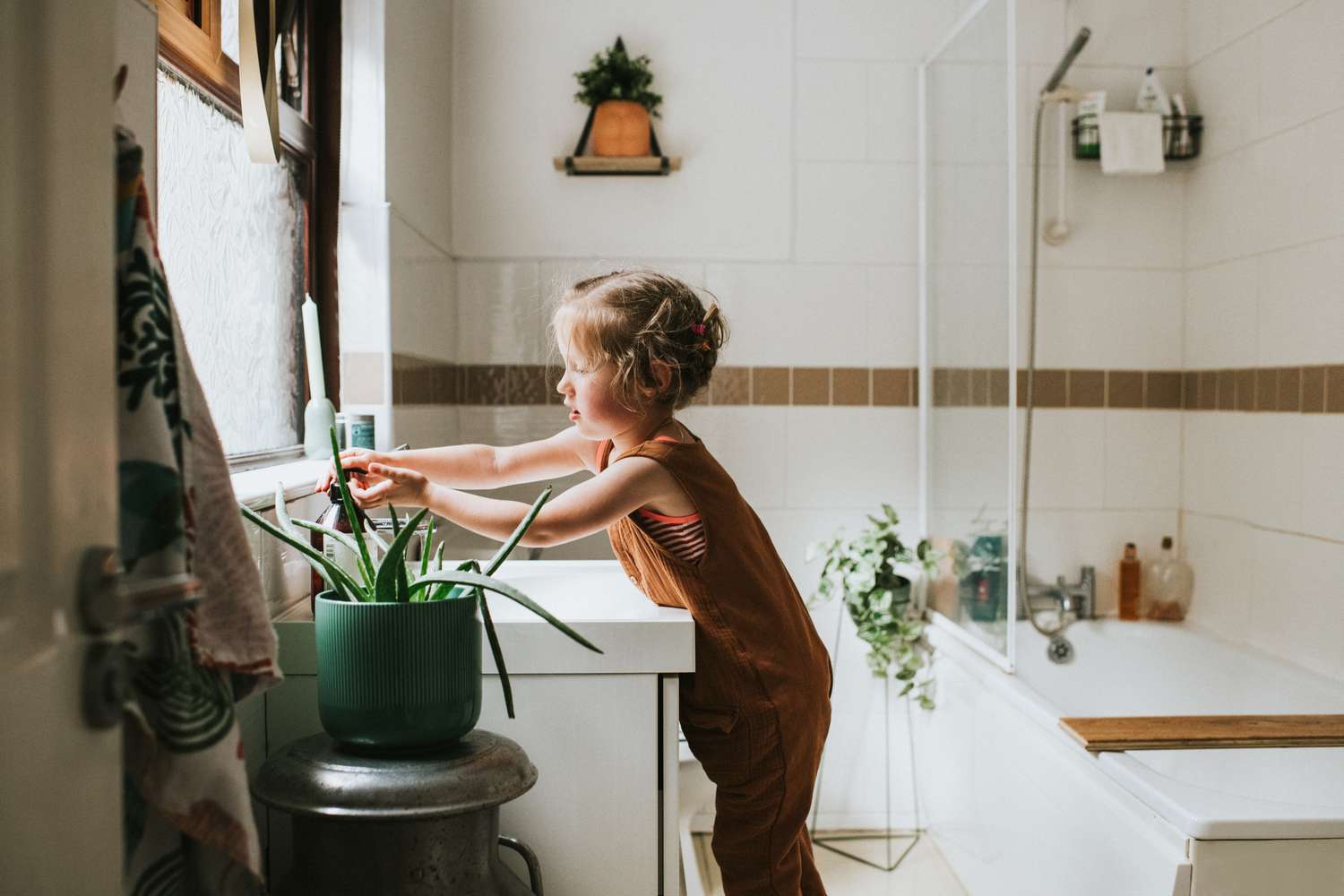 little girl washing her hands at a bathroom sink