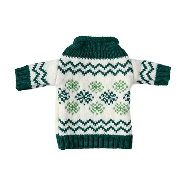 A knitted sweater with green and white patterns and long sleeves