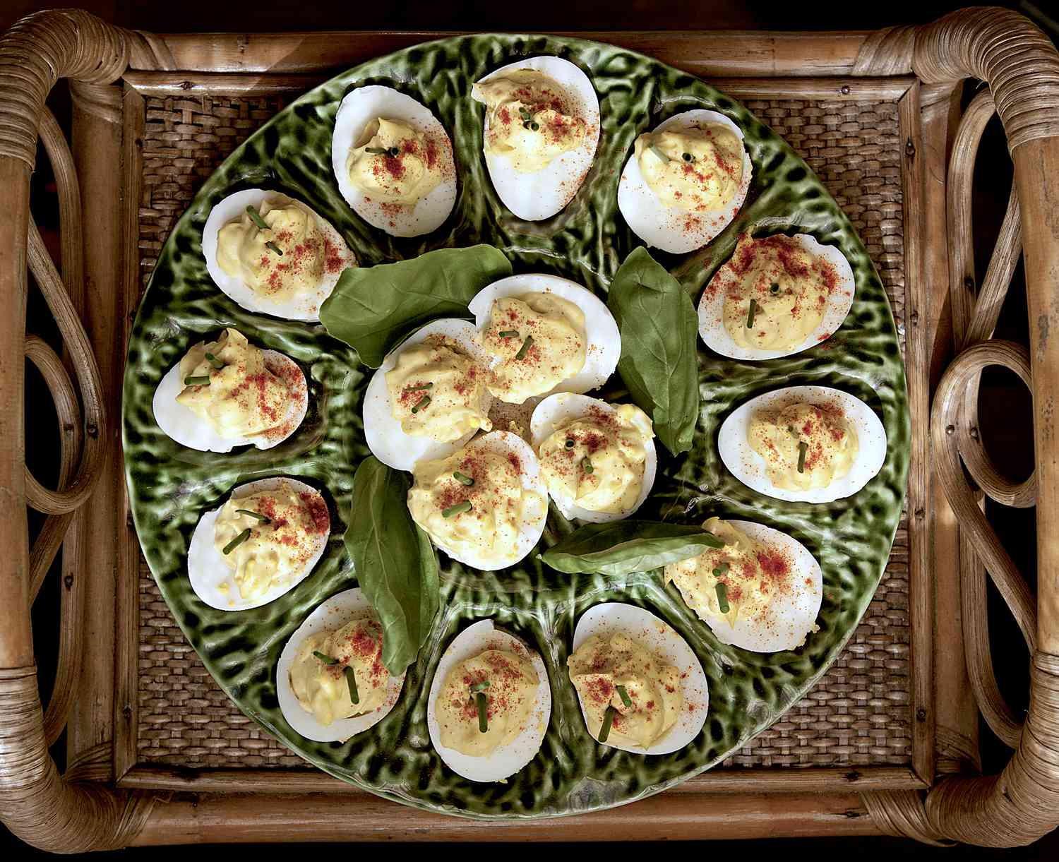 serving plate of deviled eggs on antique bamboo serving tray