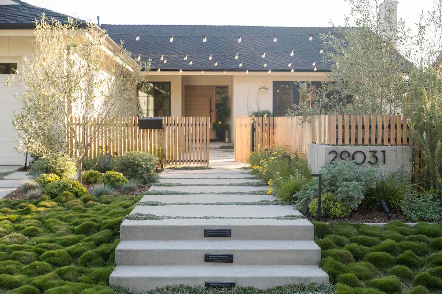House with landscaped lowmaintenance ground cover and a modern wooden fence