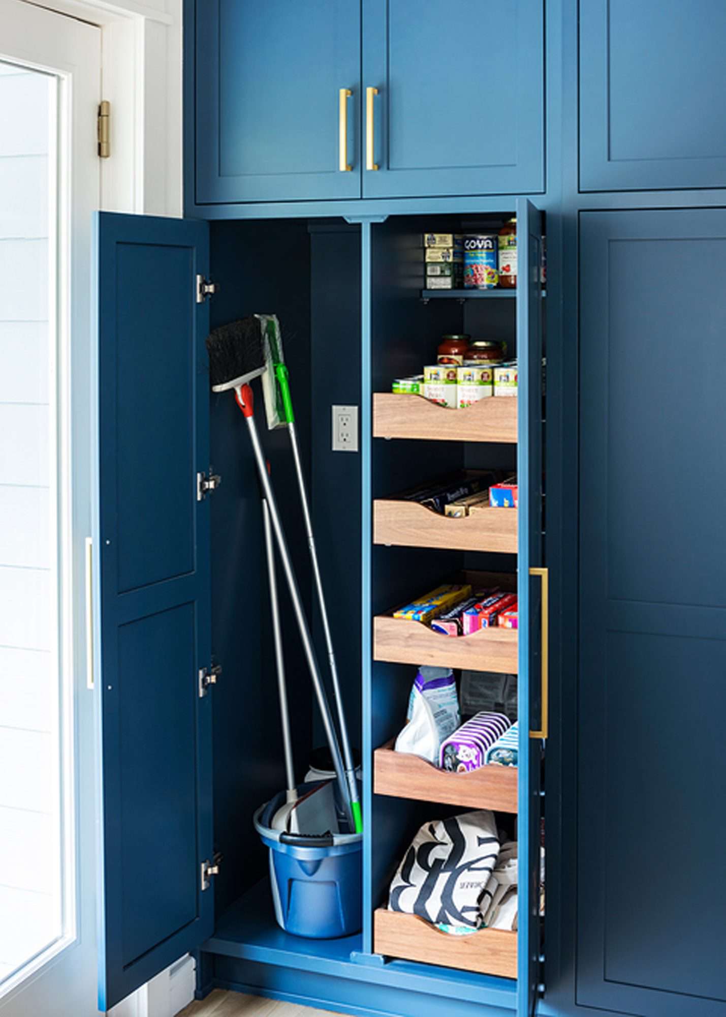 pantry organization broom closet and drawers in blue kitchen