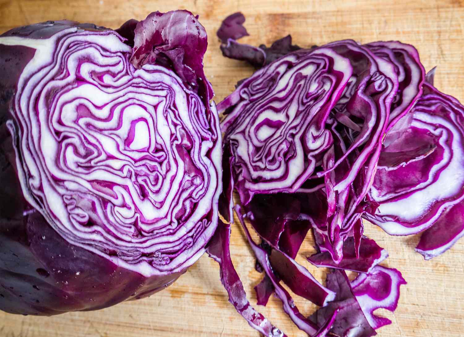 close up of red cabbage sliced on a wooden board