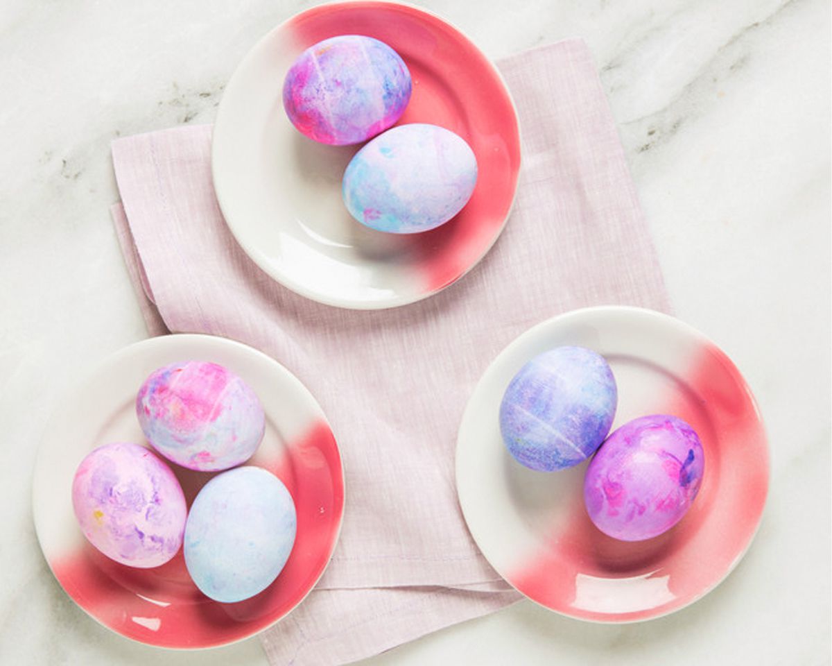 dyed pink and purple easter eggs shaving cream on plates